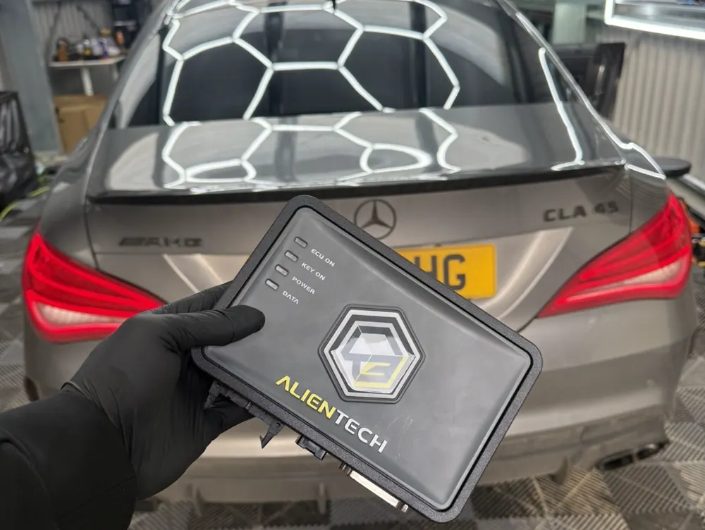 KESS3 tool held in front of a Mercedes CLA 45 in the CB Autotuning unit